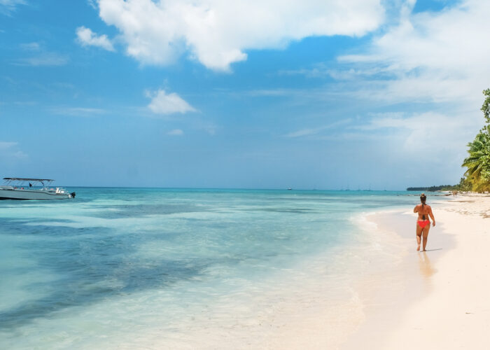 woman walking on caribbean beach.