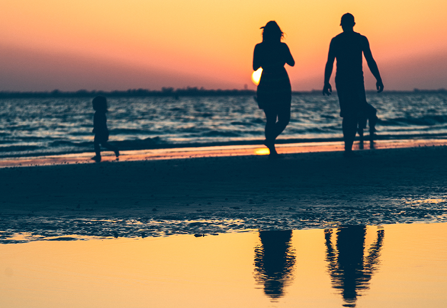 silhouette of family on beach