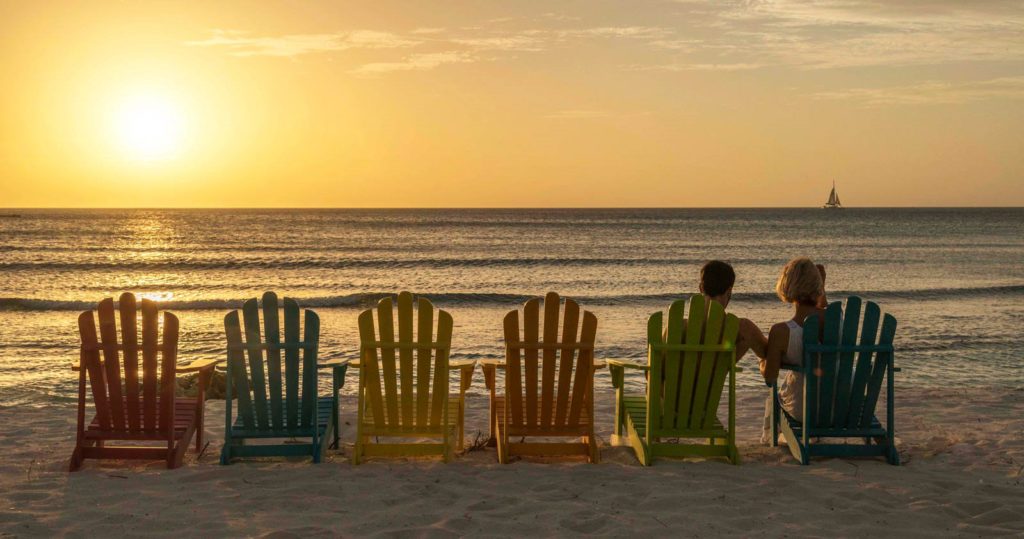 Couple watching the sunset on the beach at the Divi Carina Bay Beach Resort & Casino, St. Croix 