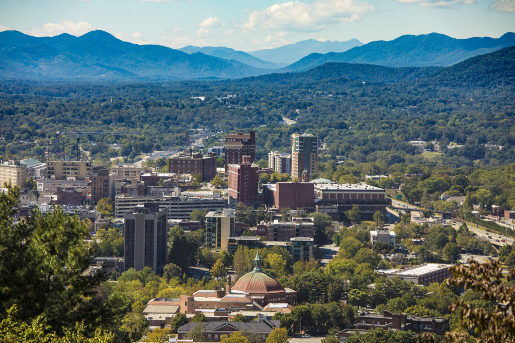 Aerial view of Asheville, North Carolina with a backdrop of the Blueridge Mountains
